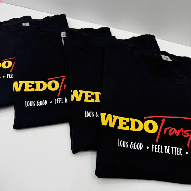 folded black  tshirts  printed with direct to film with the  WEDO transform logo