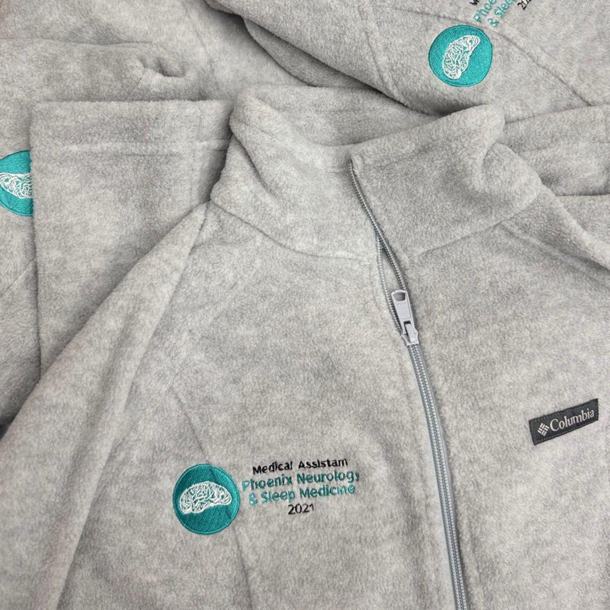 gray Zip-up fleece jackets embroidered with the medical assistant phoenix neurology and sleep medicine logo