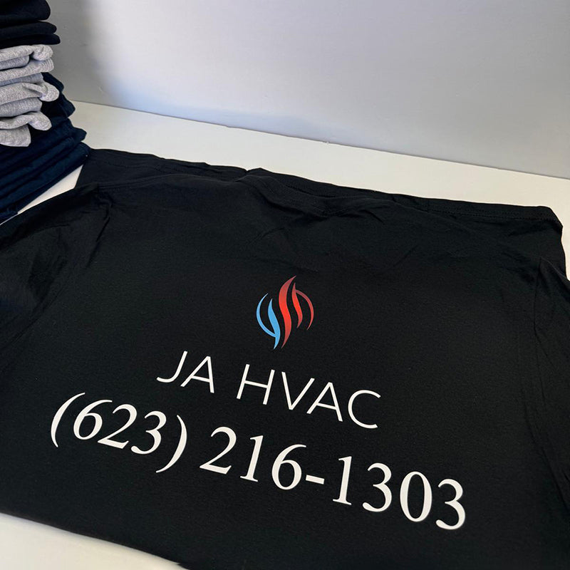 black T-shirt embroidered with the JA HVAC logo and phone number